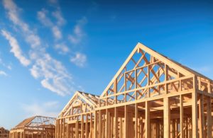 Vista angolata delle strutture in legno di una serie di edifici in costruzione con tetto spiovente